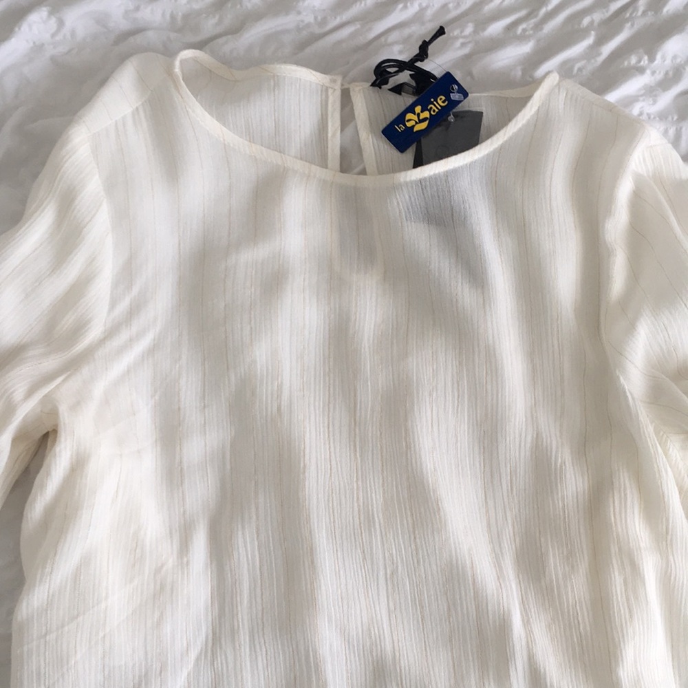 Beautiful cream-coloured bell-sleeved top